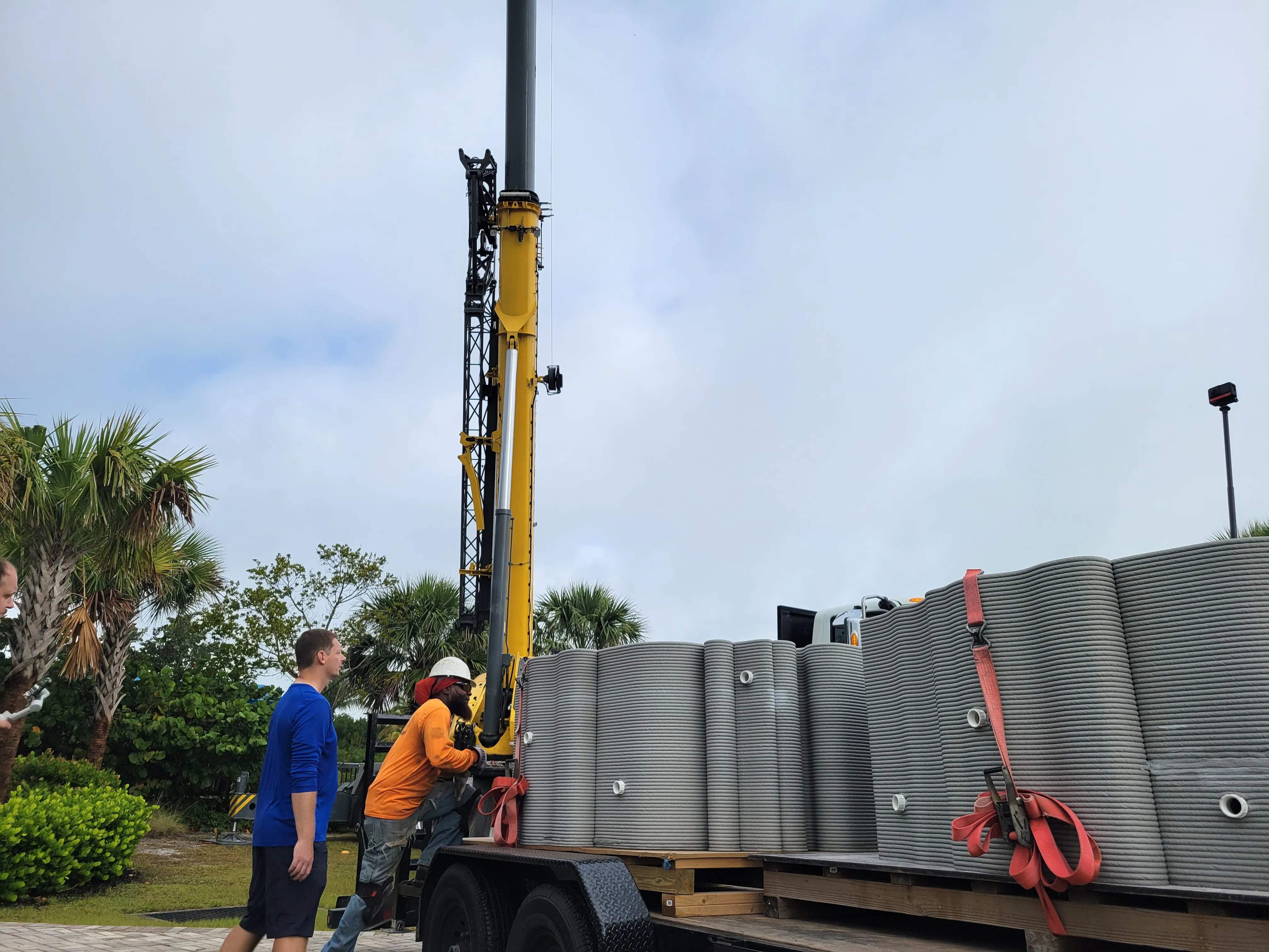 Two 3D printed reef structures on a flatbed truck ready to be lifted by crane for installation