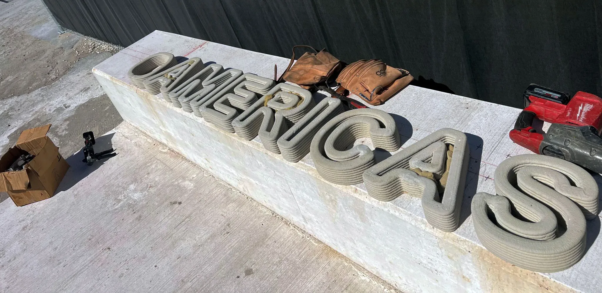Smaller concrete letters for CIMSA monument sign laid out for installation