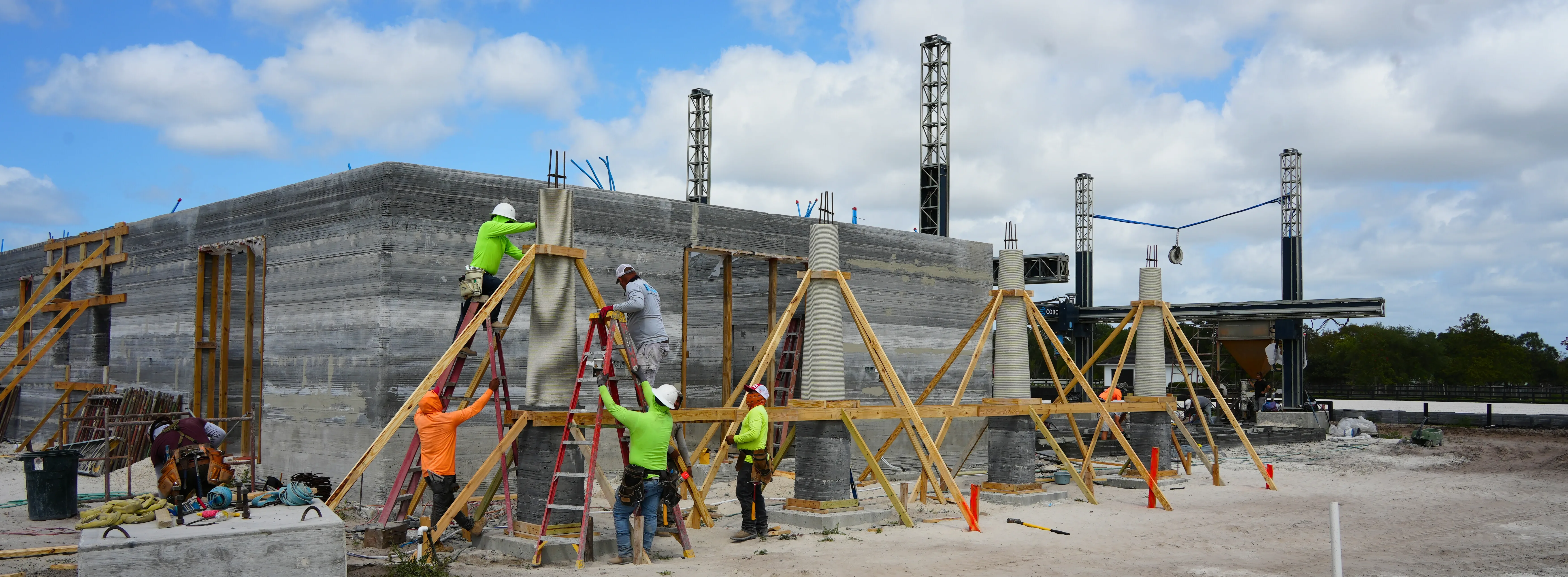 Concrete columns being installed in a row at Wellington Farms construction site