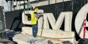Entry monument sign being installed at CIMSA Americas facility using 3D printed concrete components