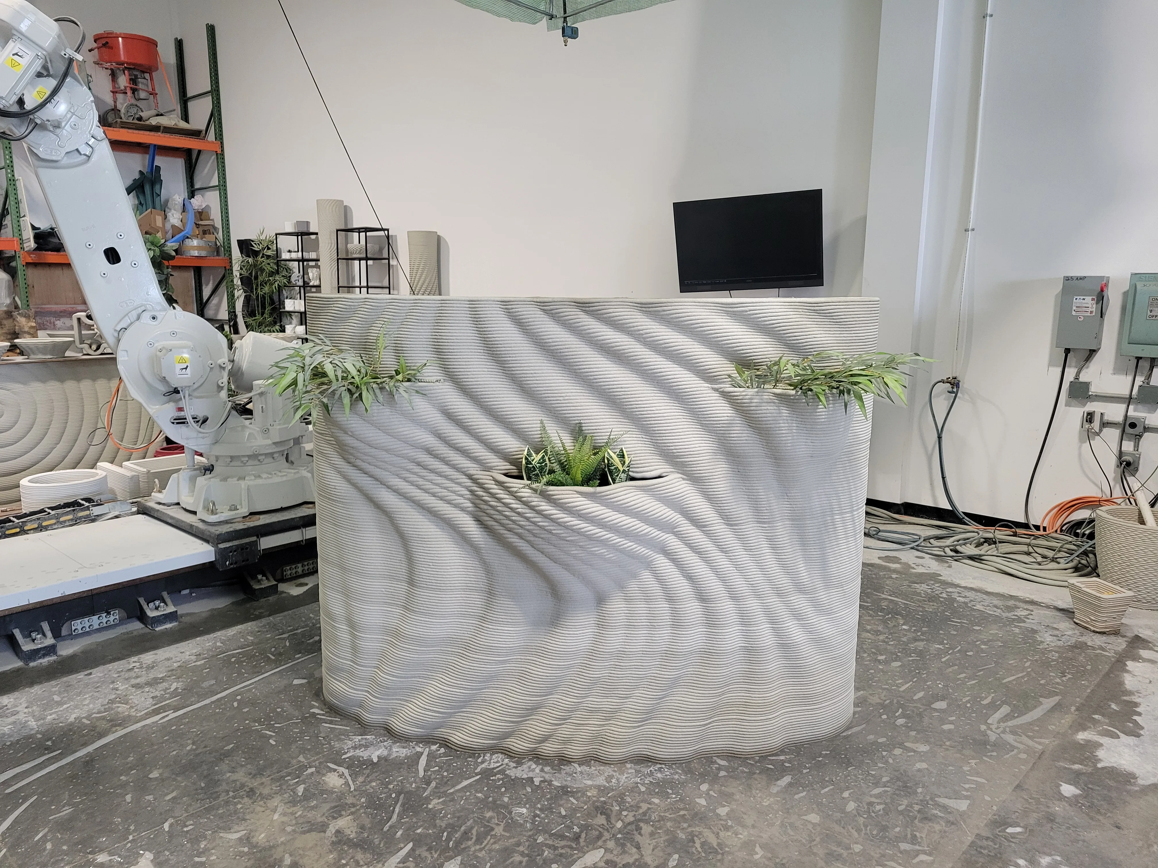 Custom concrete planter feature wall during production inside Printera shop