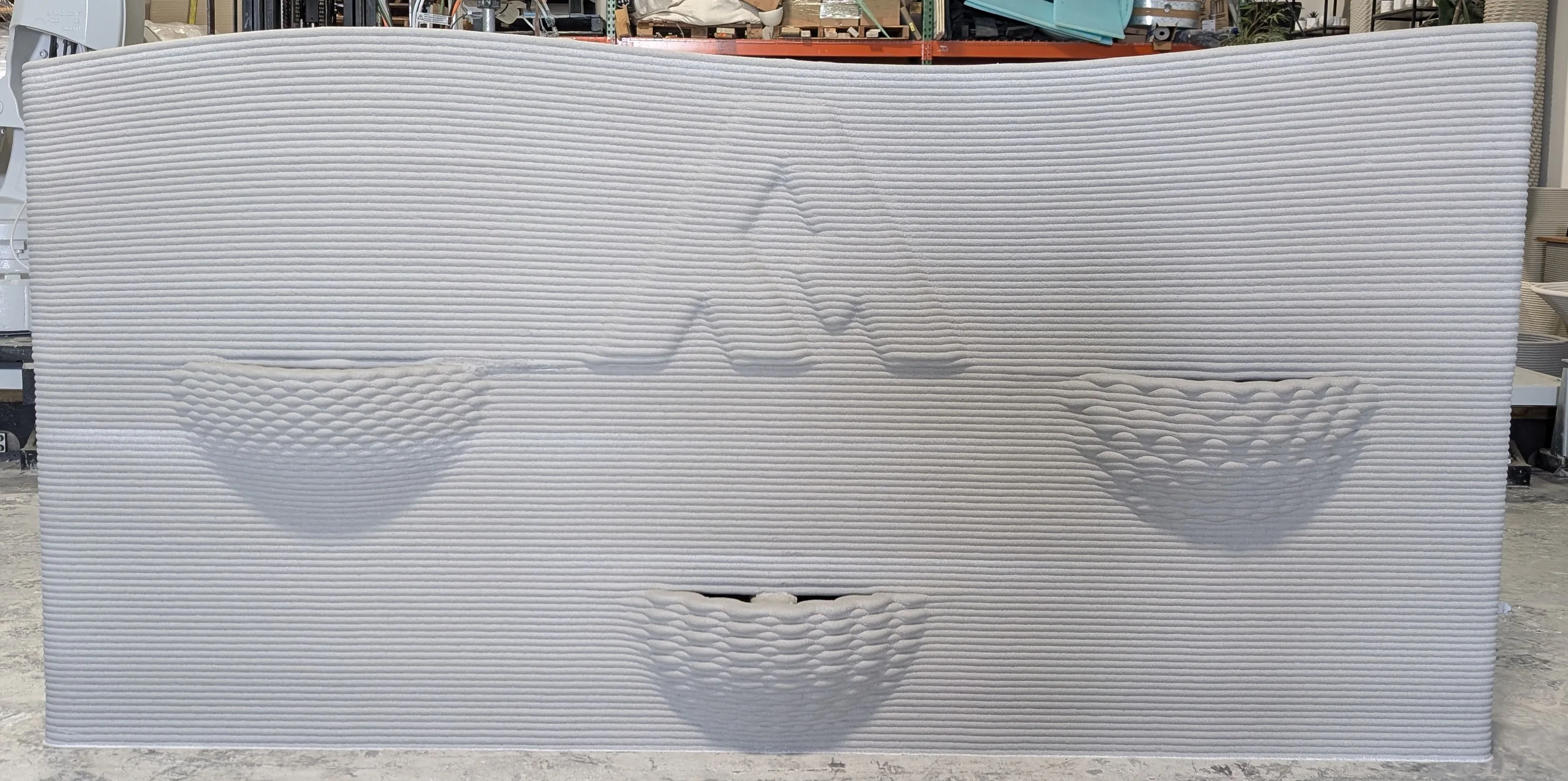 Custom concrete planter feature wall with embedded Amerimix logo