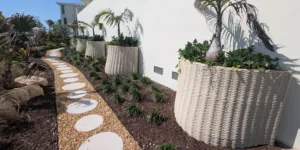 Row of custom concrete planters with wicker pattern from Coastal Oasis project