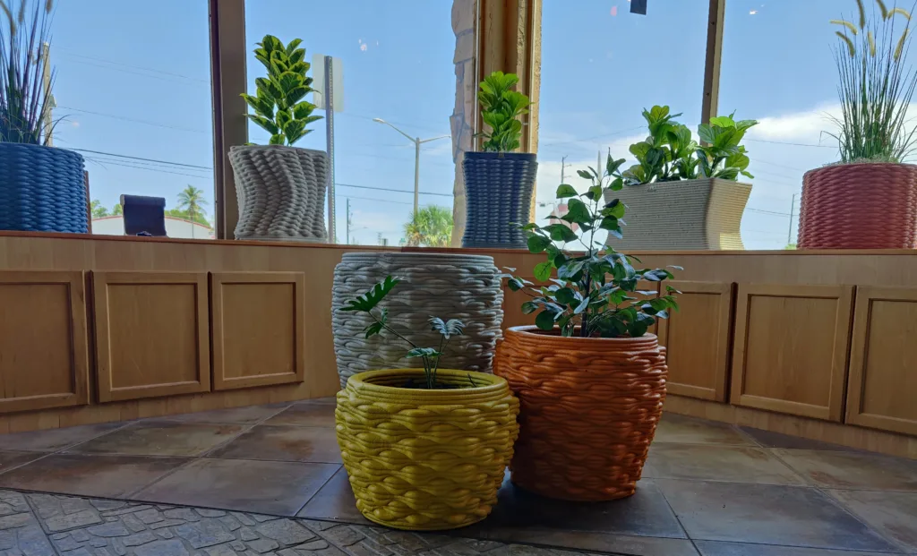 Multiple small custom concrete planters displayed in shop