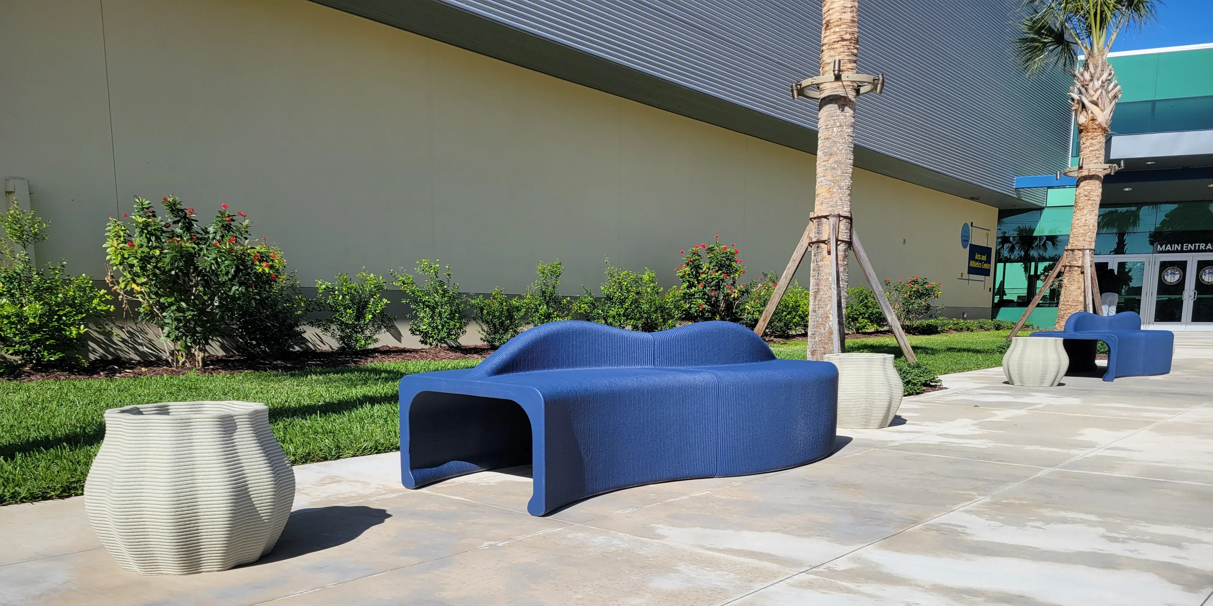3D concrete printed benches and planters installed at the Pine School courtyard, showcasing custom outdoor furniture for landscape architecture.