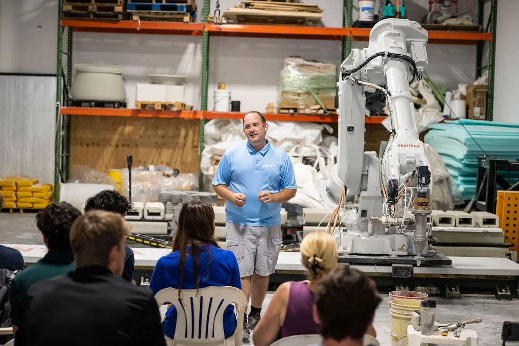 designers observing a live 3D concrete printing demo during Printera’s education and outreach event.