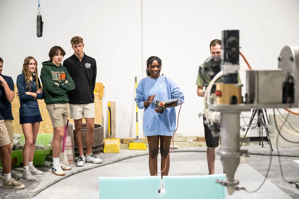 High school students participating in a robot obstacle course during a 3D concrete printing education visit at Printera.