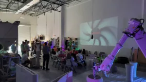 Members of the Treasure Coast Builders Association attending a 3D concrete printing education presentation at Printera with printed samples on display.